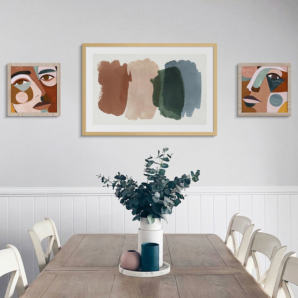 3 framed prints on wall in dining room