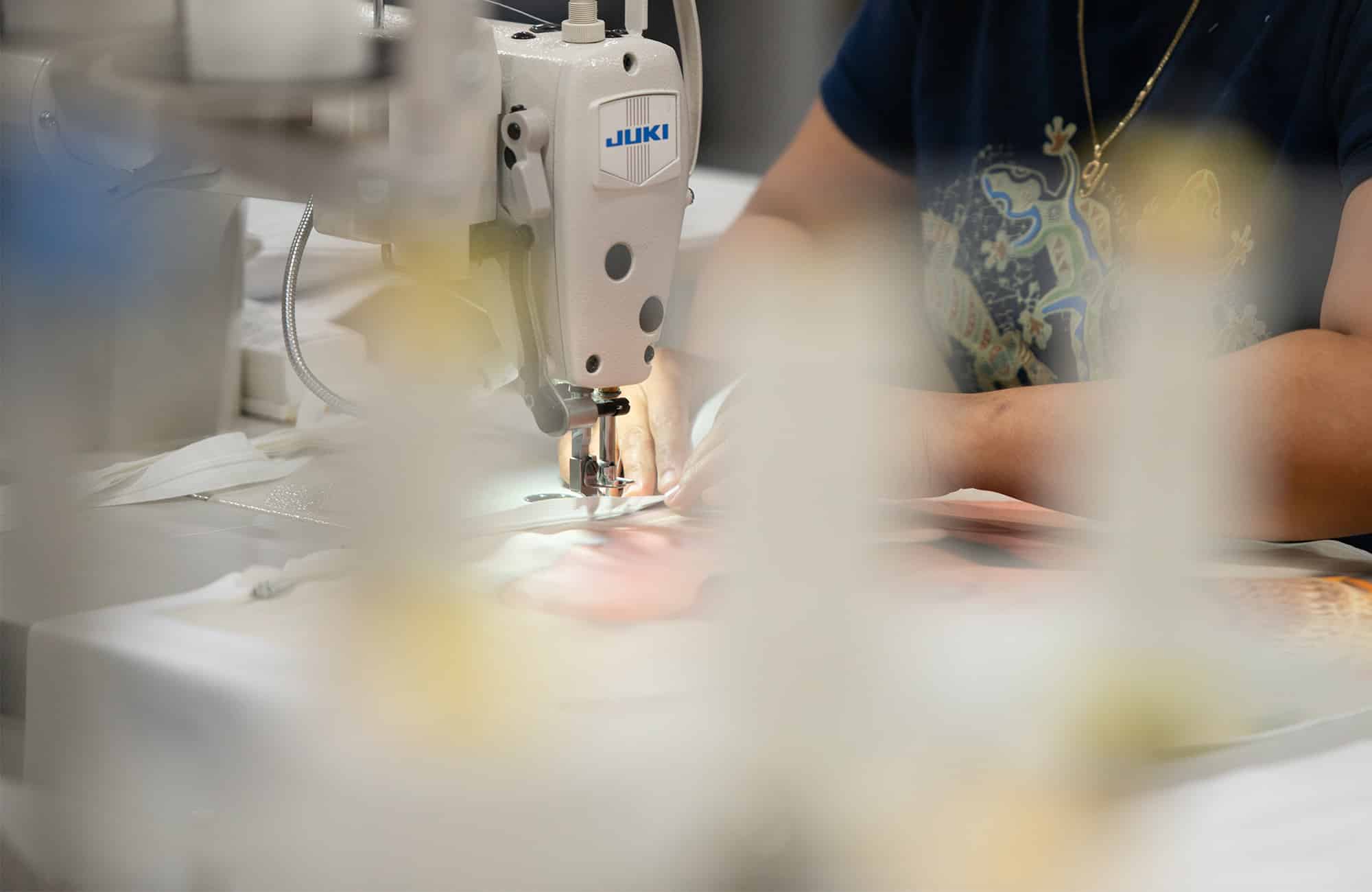 a worker sews a custom a pillow