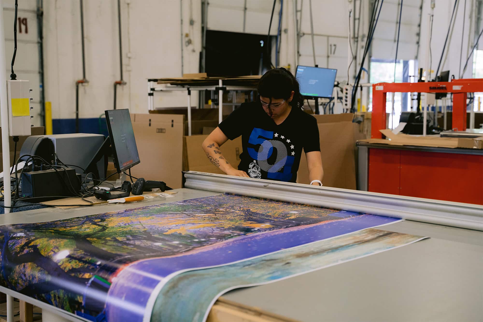 person cutting a poster print